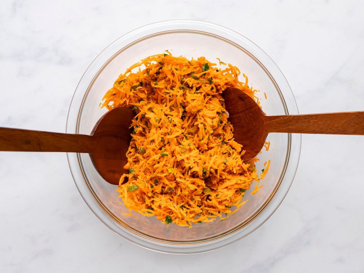tossed carrot salad in bowl.