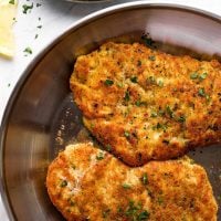 Parmesan crusted chicken in a skillet.