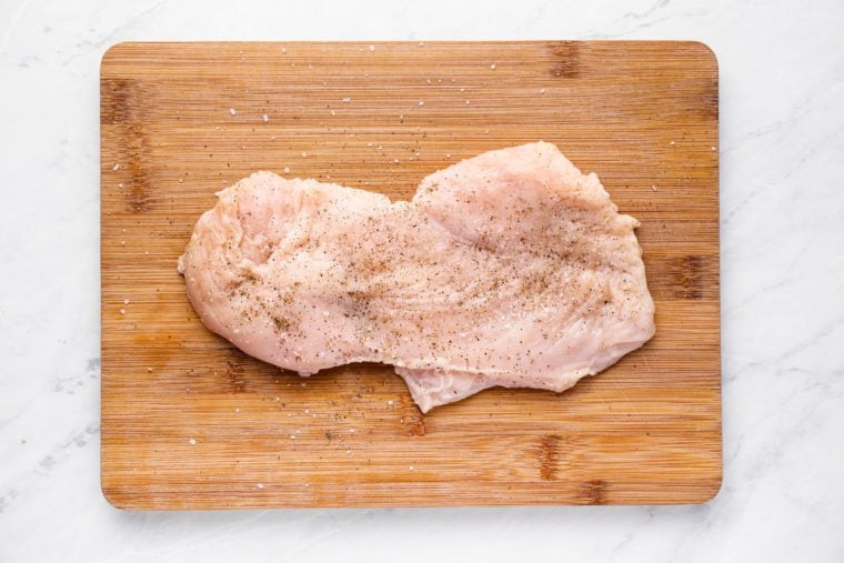 seasoning chicken with salt and pepper