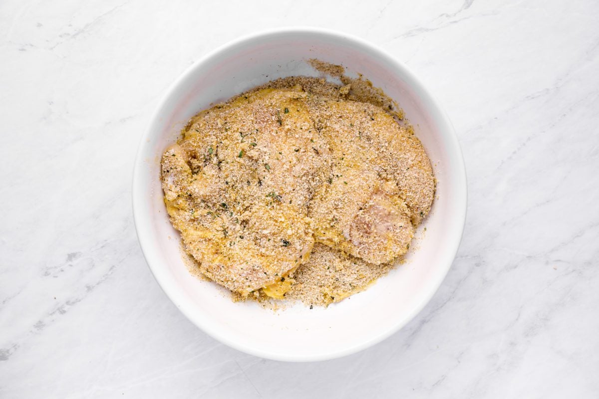 dredging chicken in bread crumb mixture