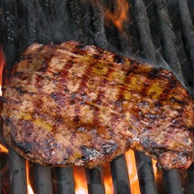 Flank steak on a grill.
