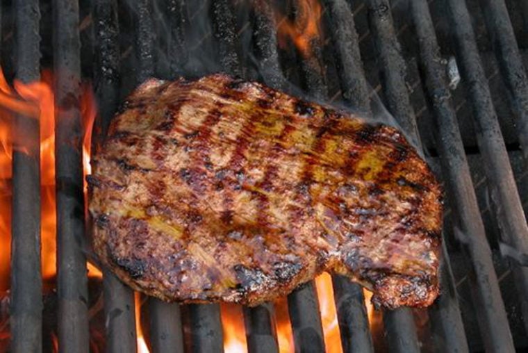Flank steak on a grill.