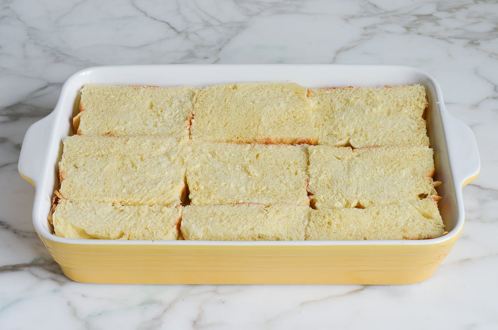 arranging brioche in baking dish