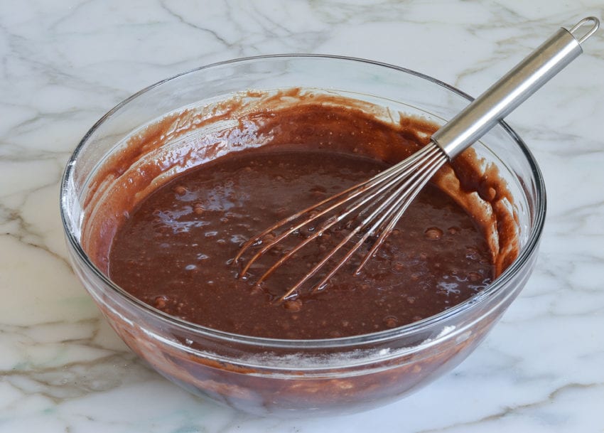 Whisk in a bowl with brownie batter.