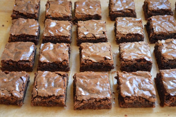 brownie squares on parchment paper
