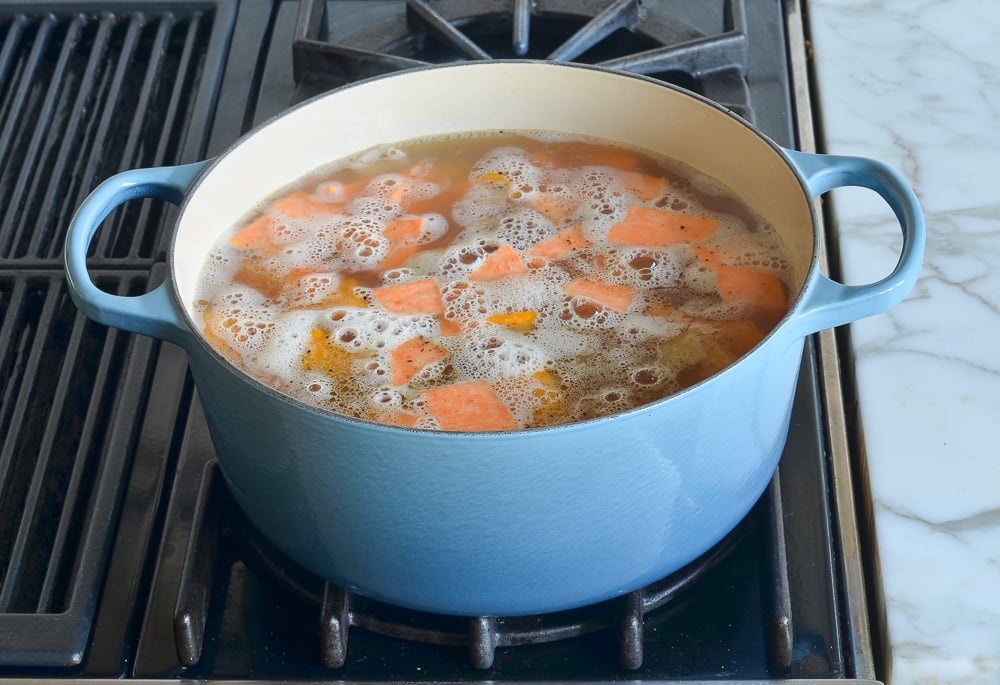 Vegetables boiling in broth.
