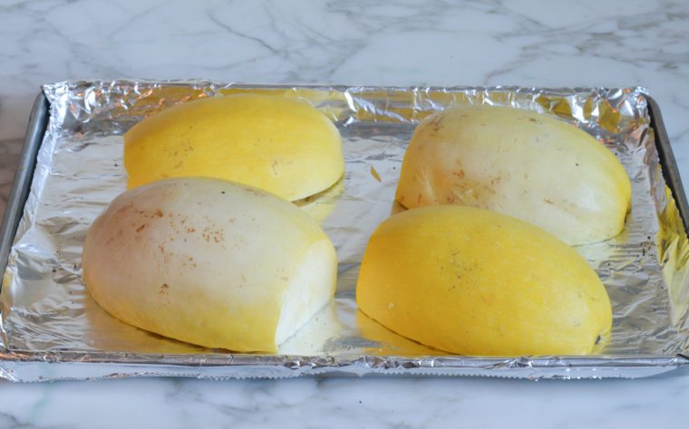 squash cut side down on baking sheet