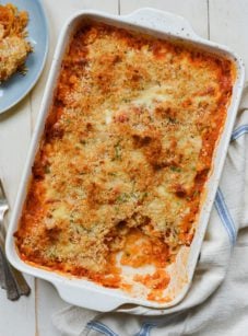 Cheesy baked spaghetti squash with marinara sauce in a baking dish.
