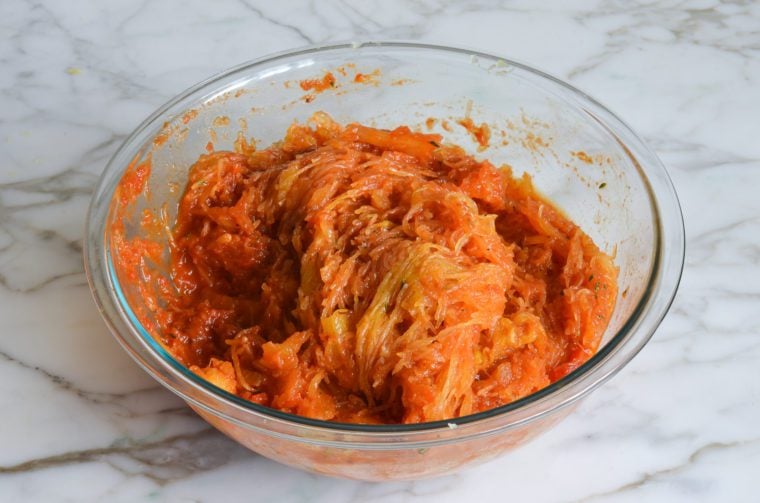 spaghetti squash mixed with sauce and seasonings