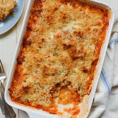 Cheesy baked spaghetti squash with marinara sauce in a baking dish.