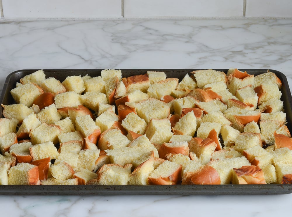 Cubes of Challah on a baking sheet.