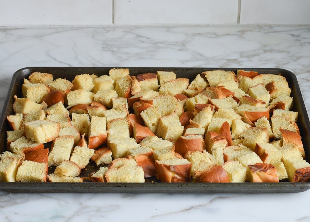 Toasted cubes of Challah on a baking sheet.