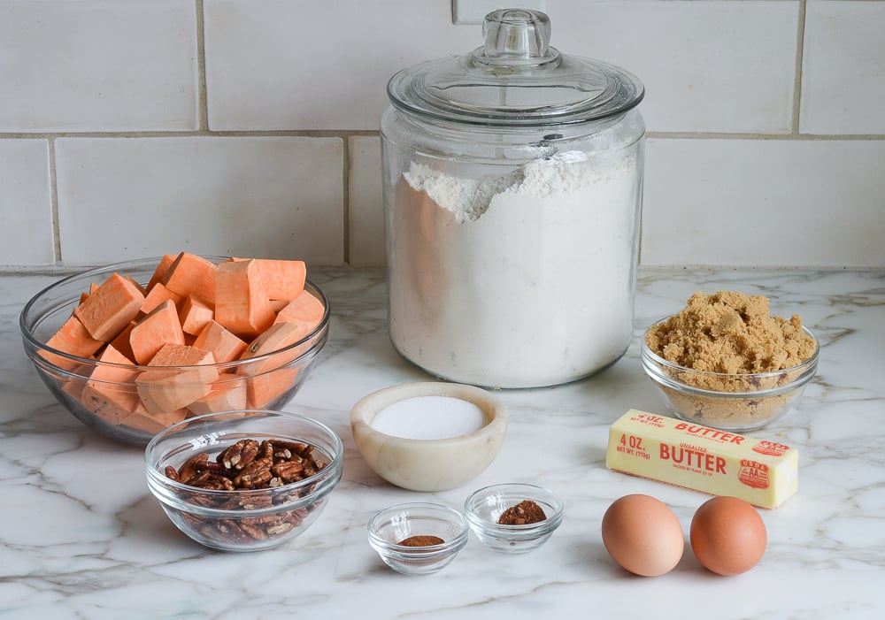 Sweet potato casserole ingredients including butter, eggs, and pecans.