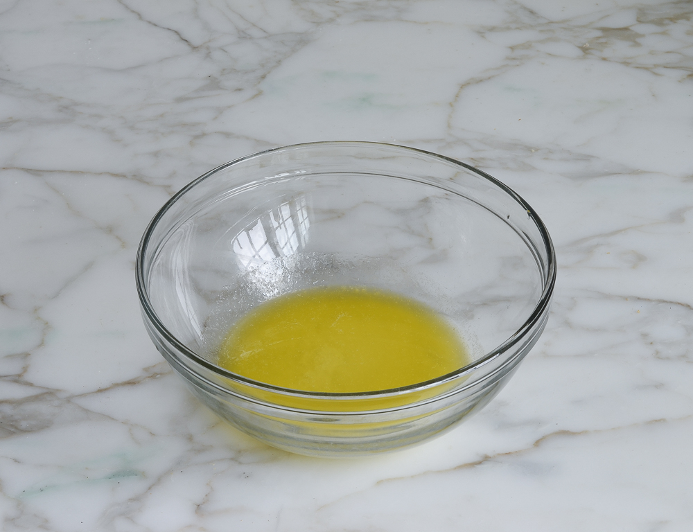 Melted butter in a glass bowl.