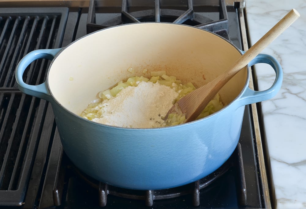 adding flour to thicken the soup.