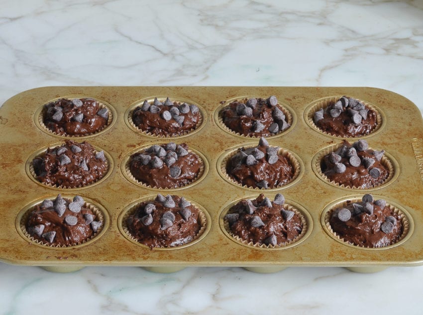 Muffin batter topped with chocolate chips.
