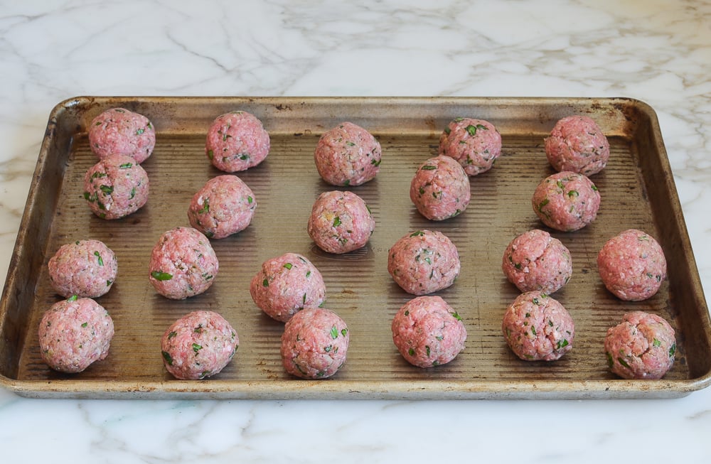 raw meatballs on sheet pan