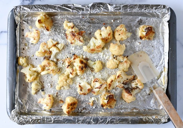 sprinkling roasted cauliflower with cheese