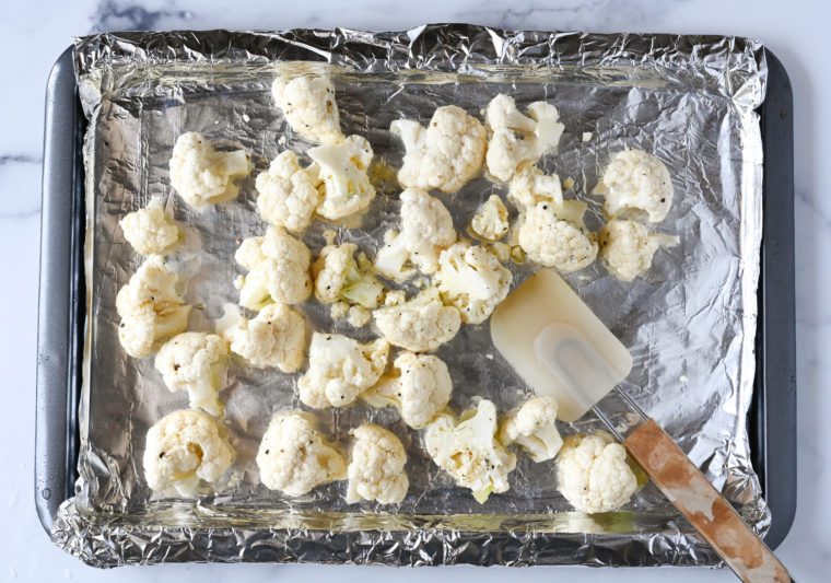tossing cauliflower with oil, salt and pepper