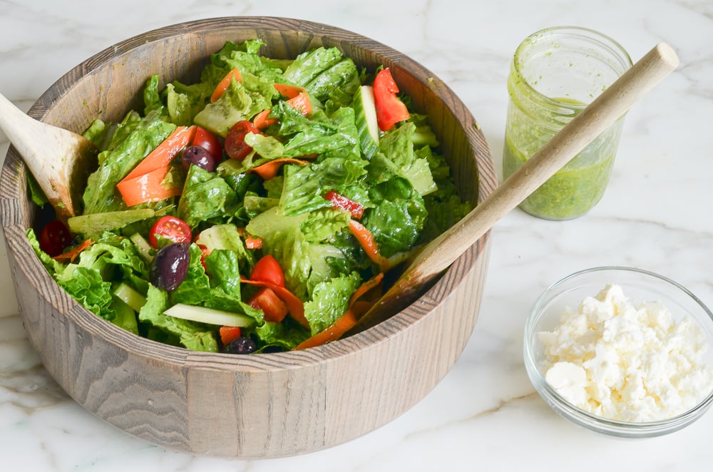 tossing Italian salad with Italian dressing