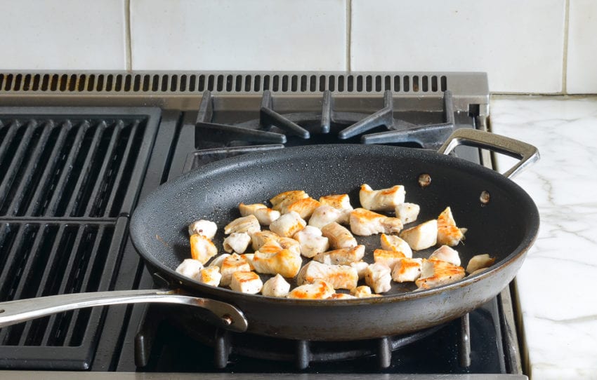 Cooked chicken in a skillet.