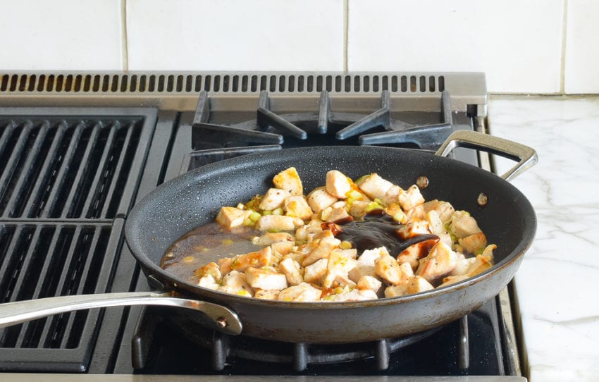 Sauce mixture and chicken in a skillet.