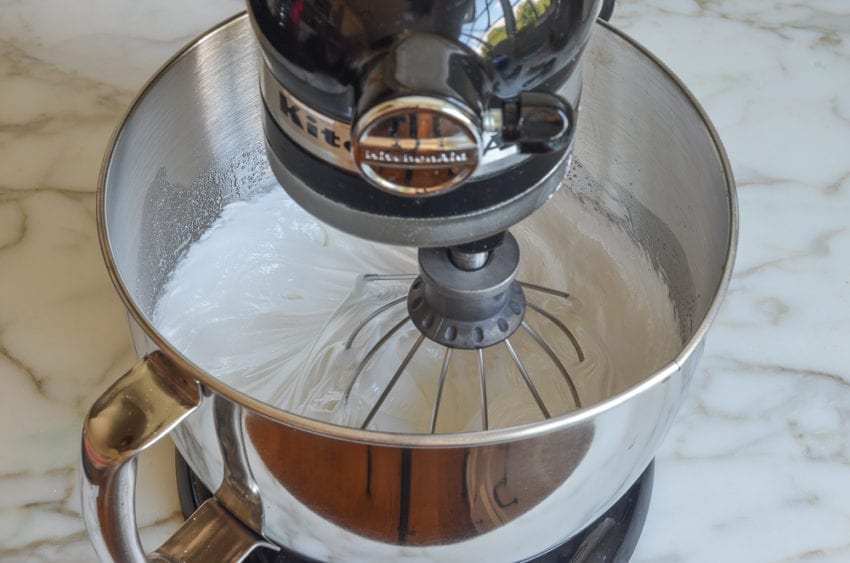 beating the meringue to stiff and glossy peaks