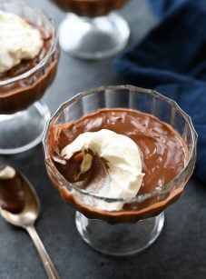 Glass of chocolate pudding missing a scoop.