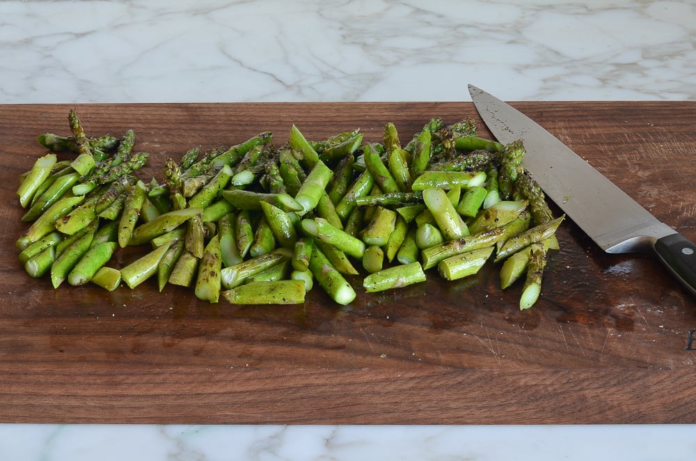 cutting grilled asparagus