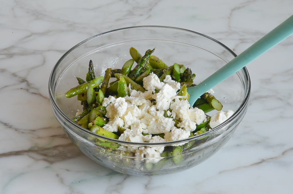 asparagus and feta in mixing bowl