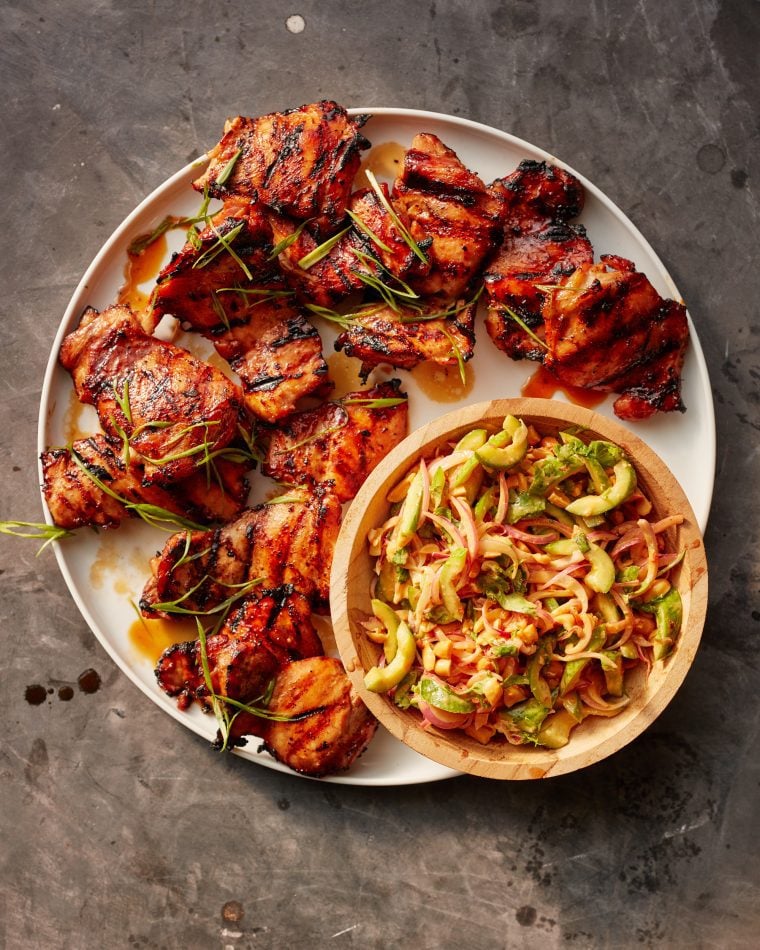 asian bbq chicken on platter with cucumber salad