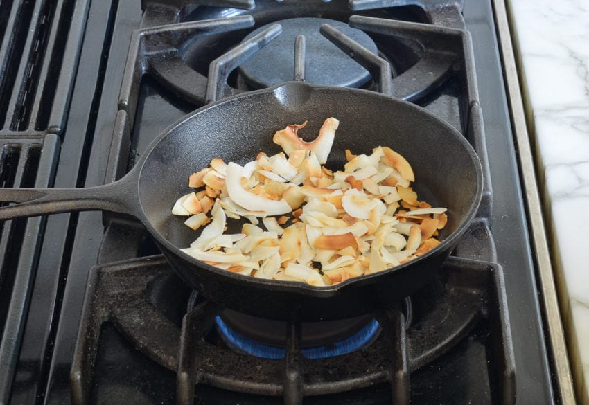 Coconut chips in a skillet.