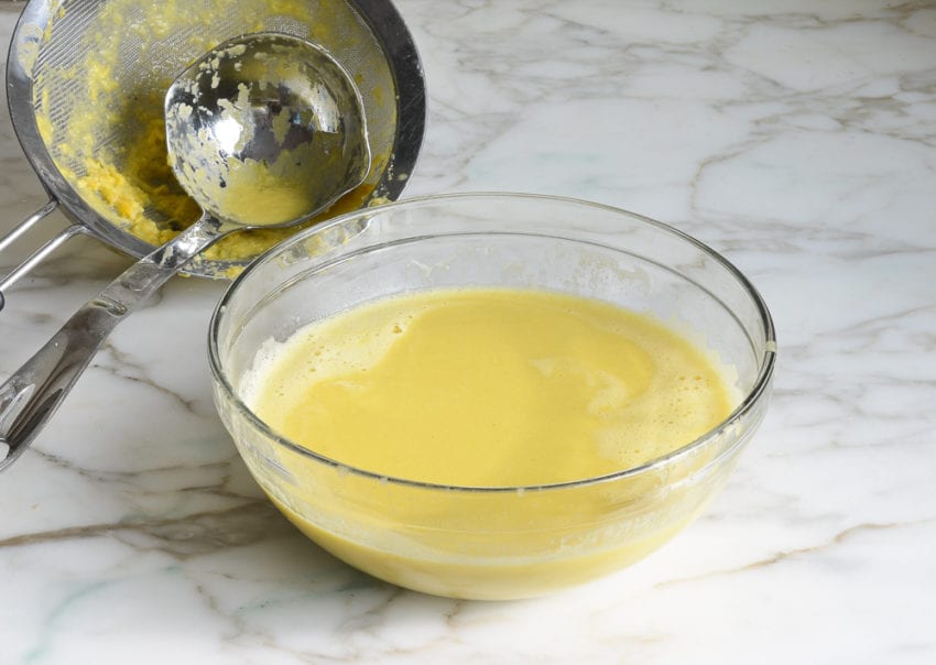 Sieve next to a bowl of soup.