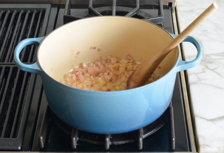 Dutch oven of cooked red onions.