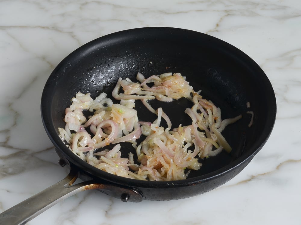Skillet of cooked shallots.
