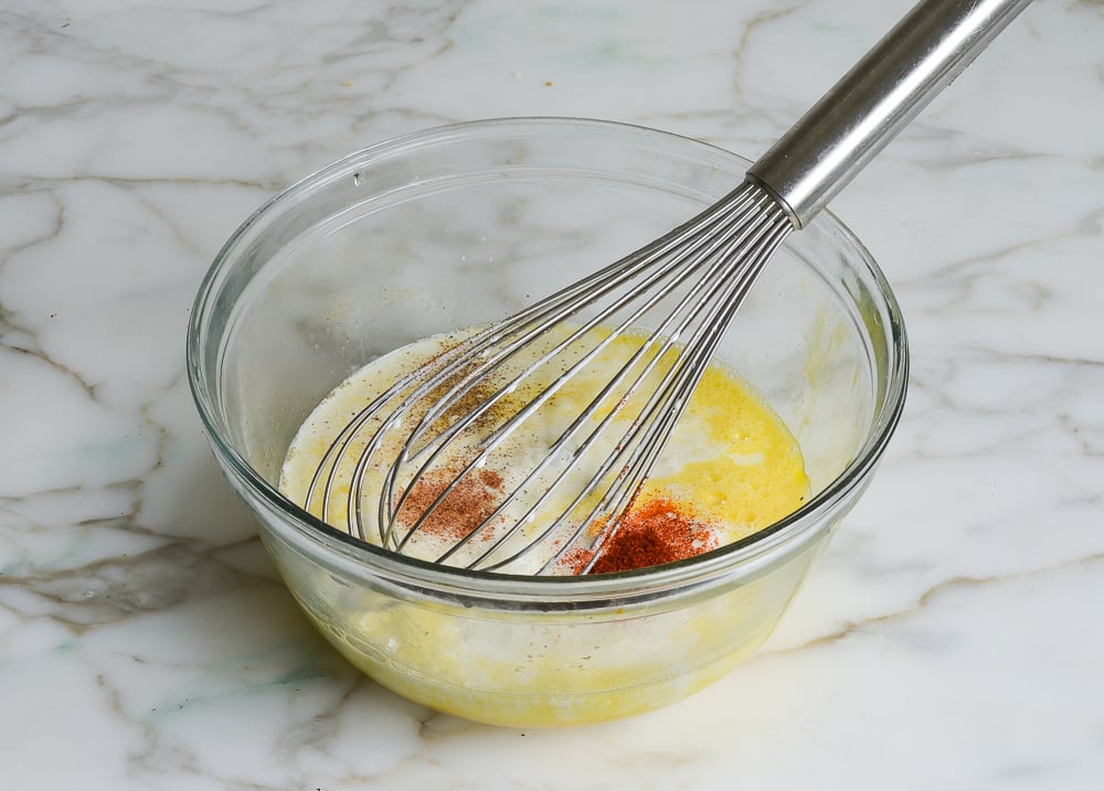 eggs, cream, and seasoning in bowl