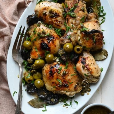 Chicken marbella on a platter.