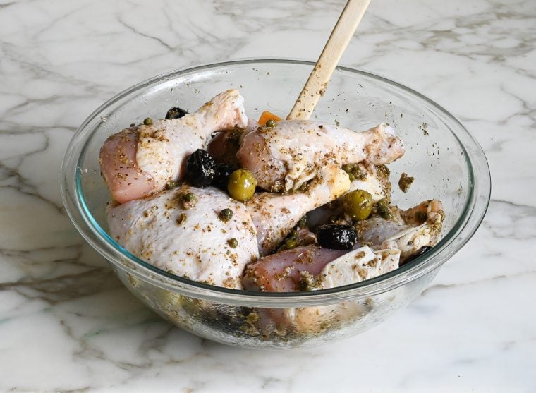 chicken with marinade in bowl