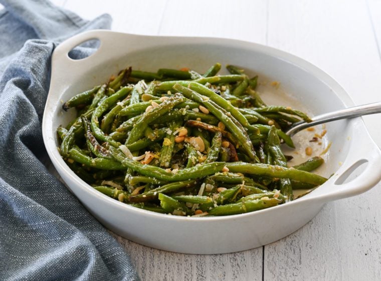 Roasted green beans in a serving dish.