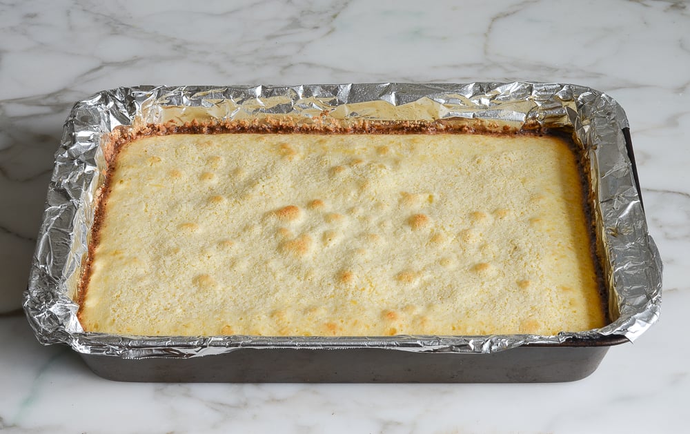 Baked lemon bars in a foil lined pan.