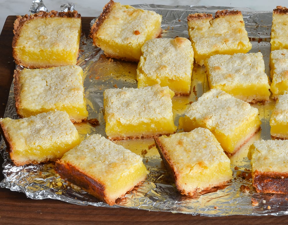 Sliced lemon bars on a piece of foil.