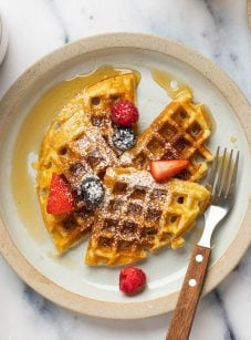 Yeasted waffles on a plate with a fork.