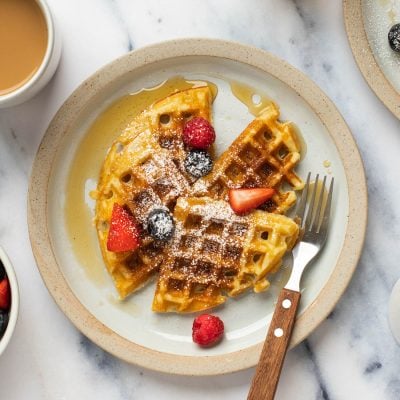 Yeasted waffles on a plate with a fork.