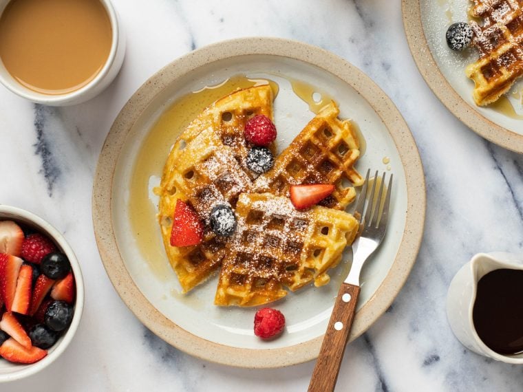 Yeasted waffles on a plate with a fork.