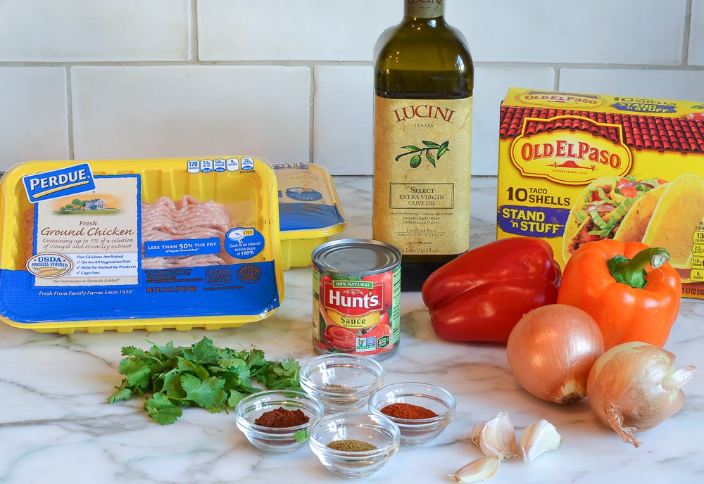 Taco ingredients including hard taco shells, tomato sauce, and garlic.