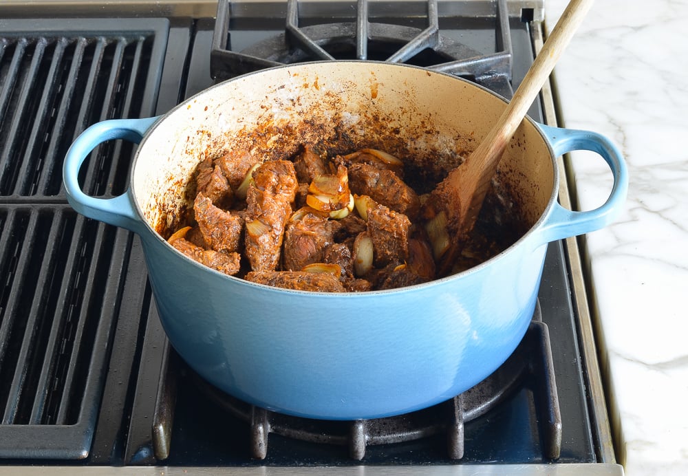 Beef mixture in a Dutch oven.