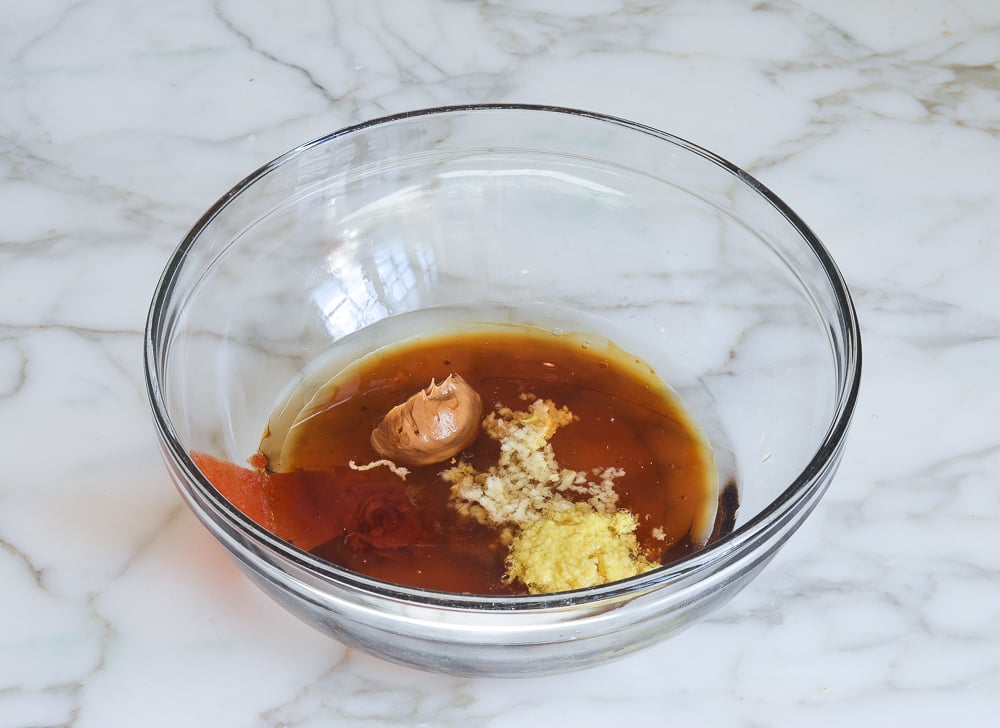 Asian slaw dressing ingredients in large mixing bowl