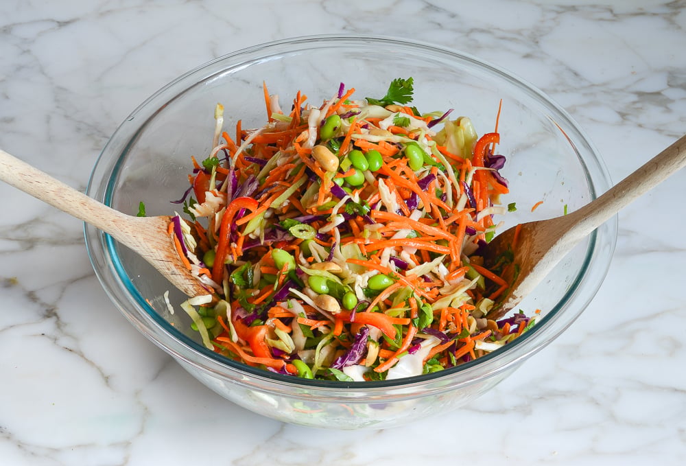 tossing Asian slaw with dressing