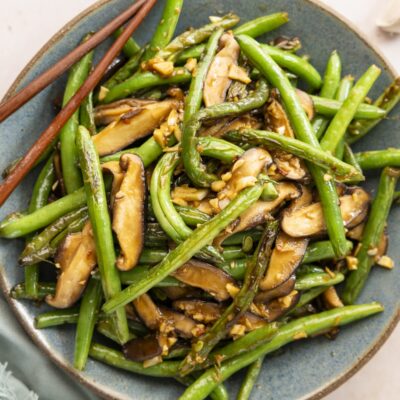 Szechuan green beans in bowl with chopsticks.