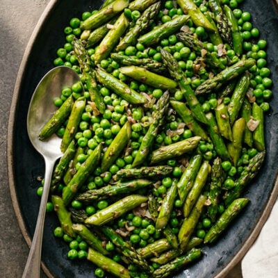 Sautéed asparagus and peas on serving platter.